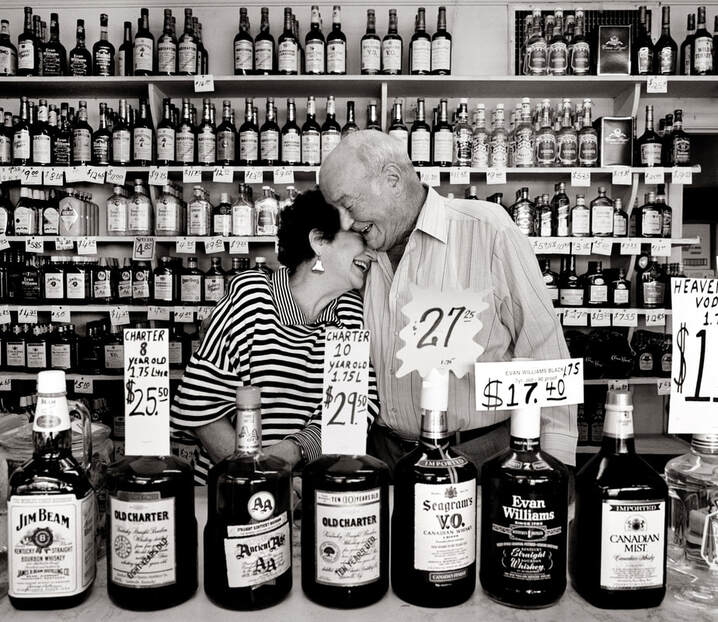 Lucille and Harold Hart hug behind the counter of their store, Dixie Liquor.